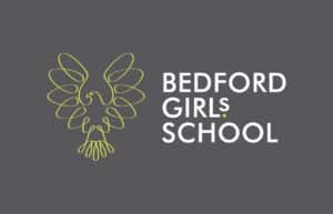 A yellow line drawing of a stylised bird next to the white text BEDFORD GIRLS' SCHOOL on a dark grey background. The L in GIRLS is highlighted in yellow.